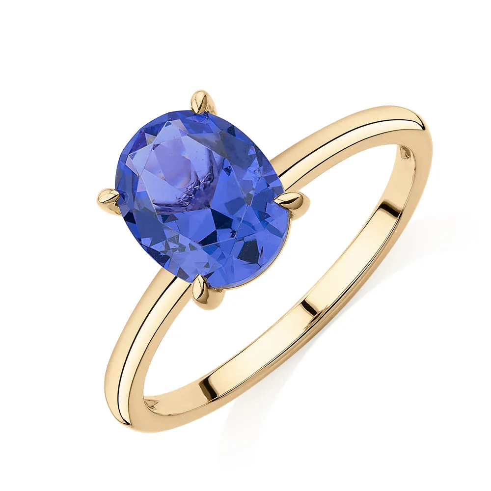 Dress ring with tanzanite simulant in 10 carat yellow gold