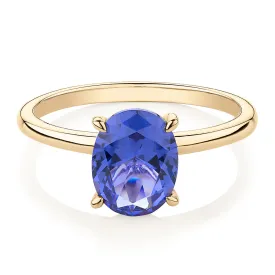 Dress ring with tanzanite simulant in 10 carat yellow gold